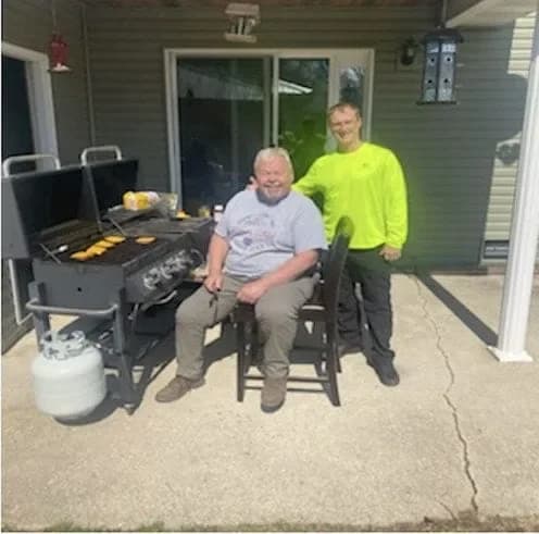Jim seated with Dave Sonner, owner of Solar Power Midwest, on his back patio after the system went live.